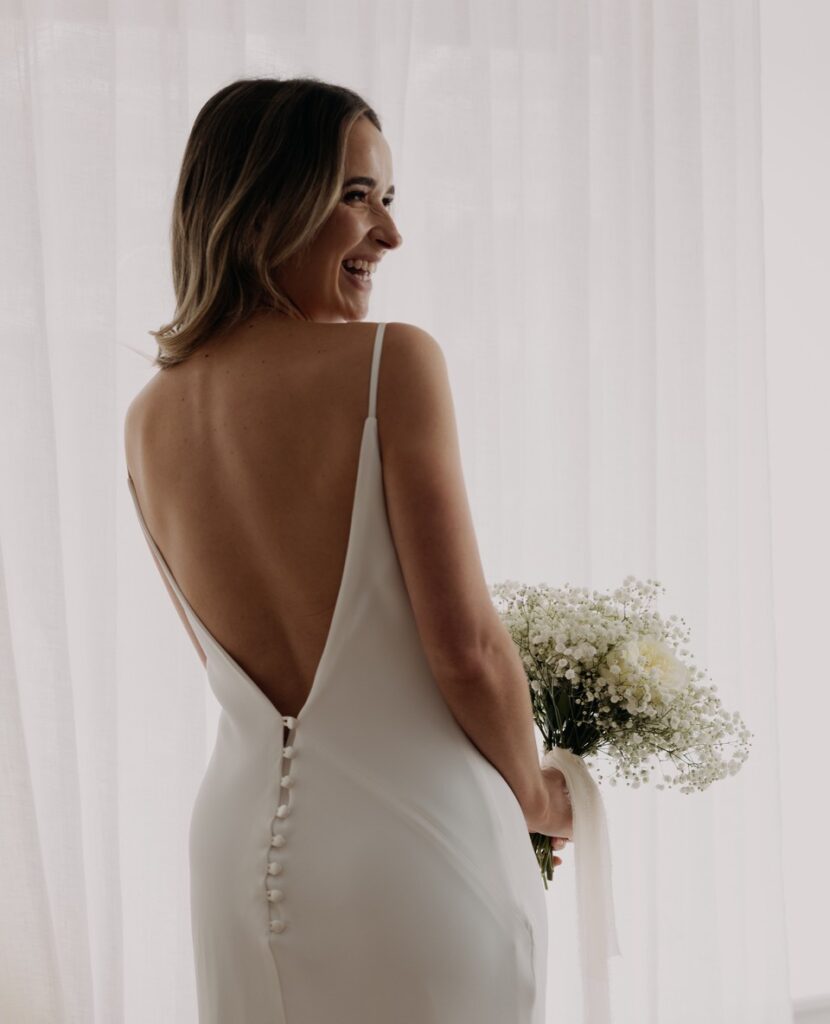 We're in love with Lottie. She's just a dream. Especially in the chic, slip dress!⁠ | Feathers & Florence | Wedding Dress Preston