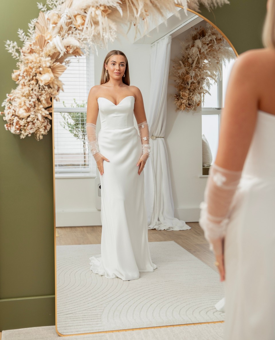 This strapless satin wedding dress is the epitome of refined sophistication | Feathers & Florence | Wedding Dress Preston